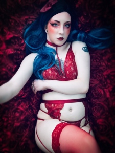 Boudoir self-portrait photo featuring red lingerie and long, blue hair. Fine art prints from this photoshoot are available in the BlessedShadows Etsy shop